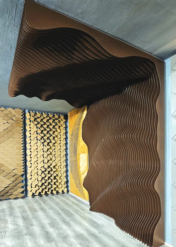 Parametric fin wall in timber finish flowing across a ceiling and wall